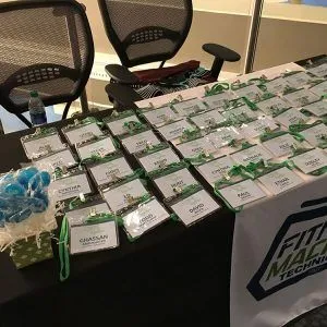 A table displaying many name tags with green lanyards